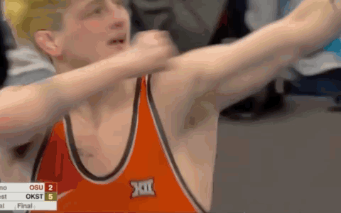 Wrestler Dabbing in Orange Singlet With XII