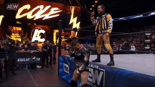 Wrestler Giving Thumbs Up in Front of AEW Banner