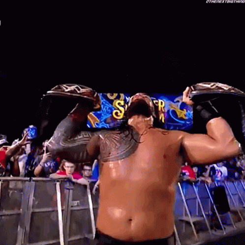 Wrestler Holding Championship Belt Over Head