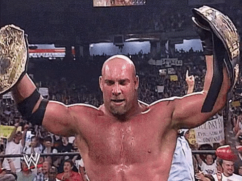 Wrestler Holding Championship Belts Before Crowd