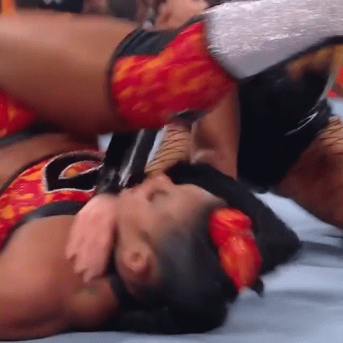Wrestler Holding Sword On Top Of Another GIF