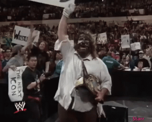 Wrestler Holding Trophy Crowd Sign The Next Icon