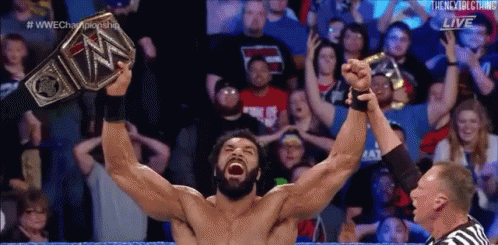 Wrestler Holding Up WWE Championship Belt