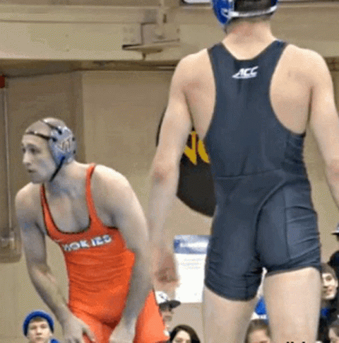 Wrestler in ACC Uniform Next to Wrestler in Orange Tank Top