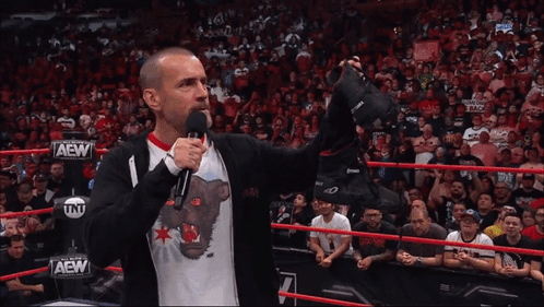 Wrestler in AEW Shirt Holding Shoes