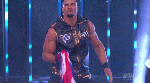 Wrestler in Black and Gold Holding Flag