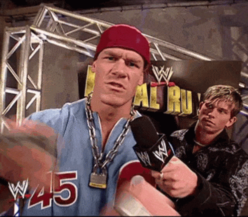 Wrestler In Blue Jersey #45 Speaking Into Microphone GIF