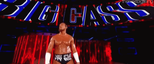 Wrestler In Front Of Big Cass Sign GIF