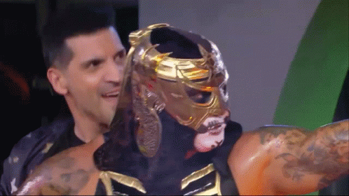 Wrestler in Gold Mask Held by Man