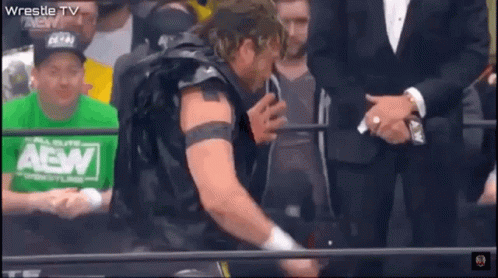 Wrestler in Green AEW Shirt Before Crowd