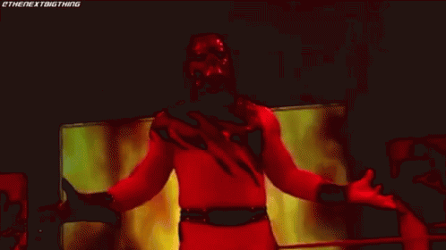 Wrestler in Red and Black Costume on Stage