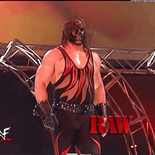 Wrestler in Red and Black in Front of Stage