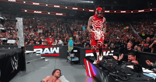 Wrestler in Red and White by RAW Sign