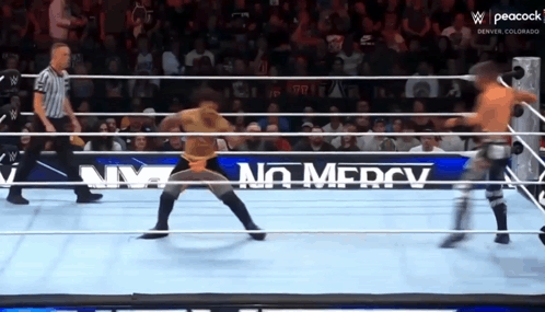 Wrestler in Ring With No Mercy Sign