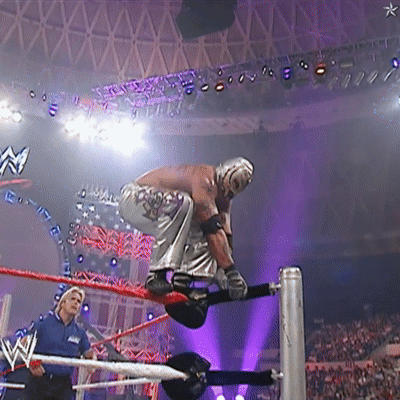 Wrestler in Ring With W Logo on Ceiling