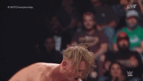 Wrestler Jumping Over Another in Ring With Referee