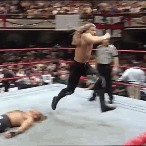 Wrestler Jumping Over Another on Ground