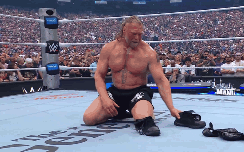 Wrestler Kneeling in Wrestling Ring The Renegade