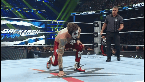 Wrestler Kneeling in Wrestling Ring With Backlash