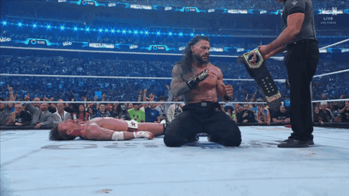 Wrestler Kneeling Over Opponent