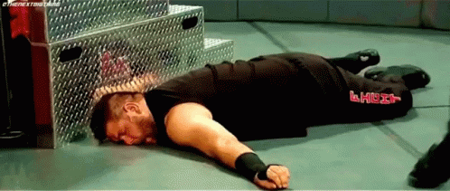 Wrestler Lying in Wrestling Ring