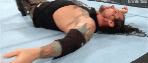 Wrestler Lying On Floor In Wrestling Ring GIF