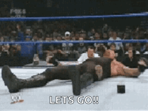 Wrestler Lying on Ring With Lets Go