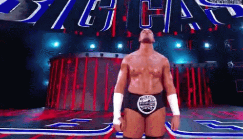 Wrestler On Stage With Sign Saying Big Chas GIF