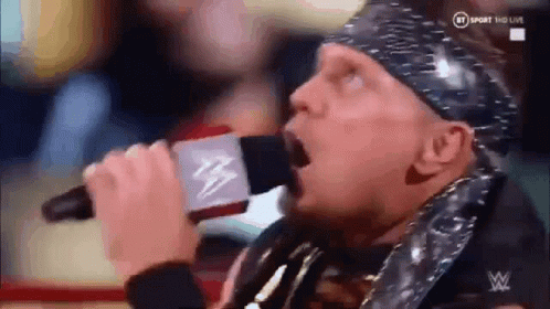 Wrestler Singing Into Microphone With Bandana