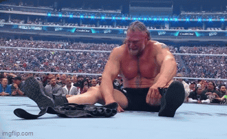 Wrestler Sitting With Crossed Feet and Belt on Ground