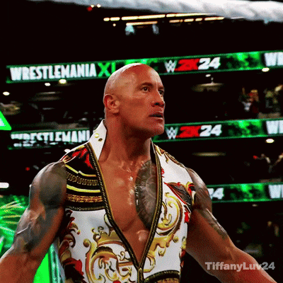 Wrestler Standing in Front of Wrestlemania Sign