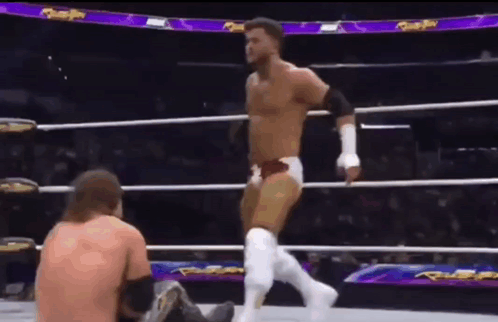 Wrestler Standing Over Seated Wrestler