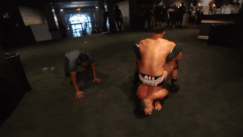 Wrestler Wearing Red And Black Knee Pads GIF