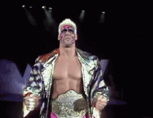 Wrestler With Belt Standing in Darkness