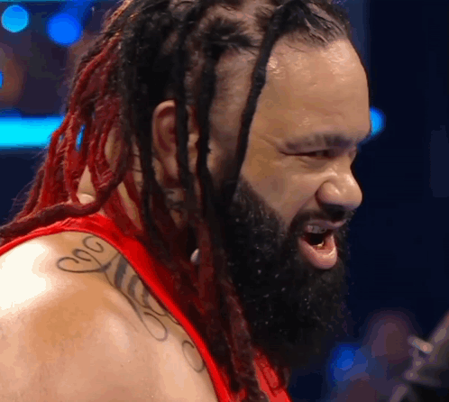 Wrestler with Dreadlocks and Beard in Red Shirt