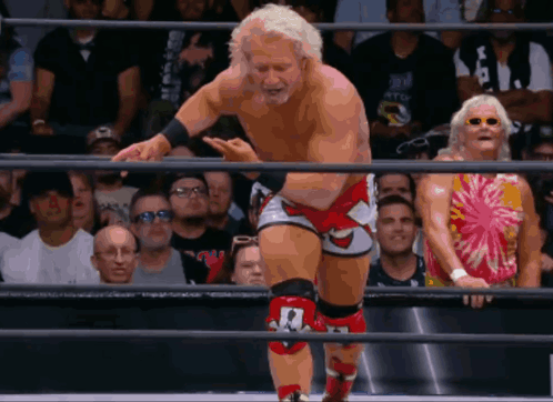 Wrestler With Number 1 On Knee In Ring GIF