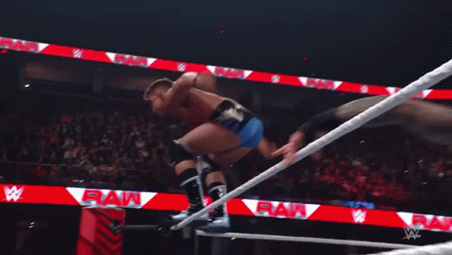Wrestlers In A Ring With One Wearing A T-Shirt That Says ' Smack Down ' On It GIF