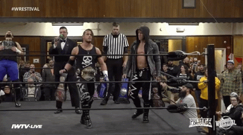 Wrestlers In A Ring With The Words #Wrestival On The Top GIF