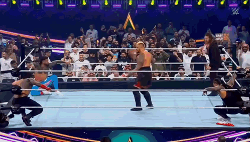 Wrestlers in Ring with Crowd and Mart Gold Sign