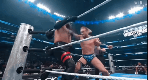 Wrestlers in Ring With WrestleMania Vegas Sign