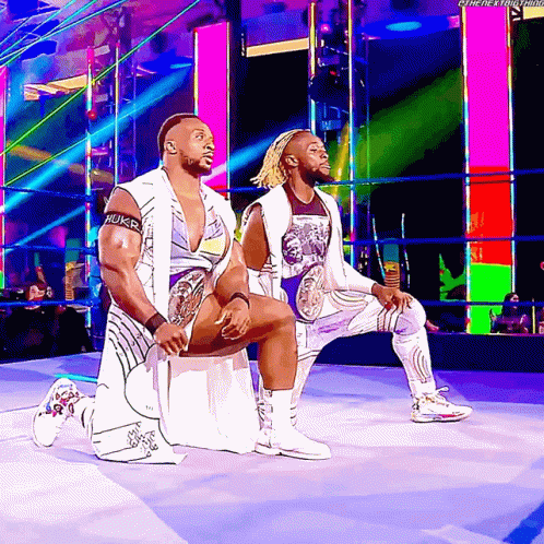 Wrestlers Kneeling in Ring With Hulk Arm