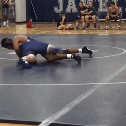 Wrestling Match in Front of Javelin Sign