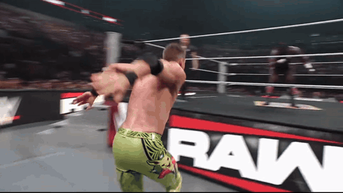 Wrestling Match in Front of Raw Banner