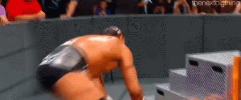 Wrestling Match With Crowd And Kneeling Wrestler GIF