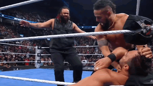 Wrestling Match With One Man Holding Arm GIF