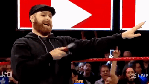 Wrestling Ring Man Pointing to Crowd With Microphone
