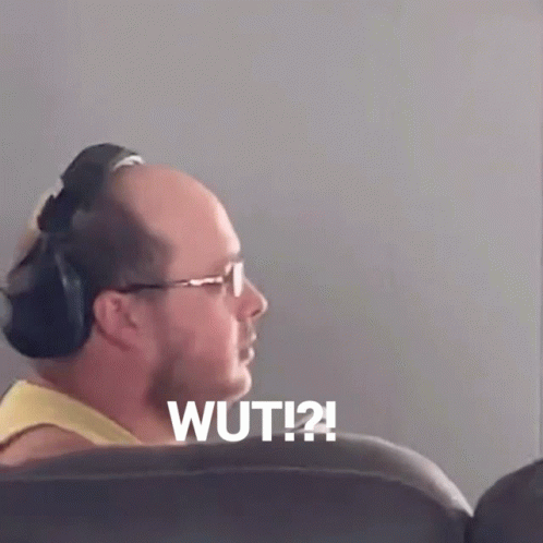Dumbfounded Wut Reaction Man Seating On Couch GIF
