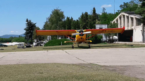 Yellow and Red Airplane With L-AE-SOL on Wing