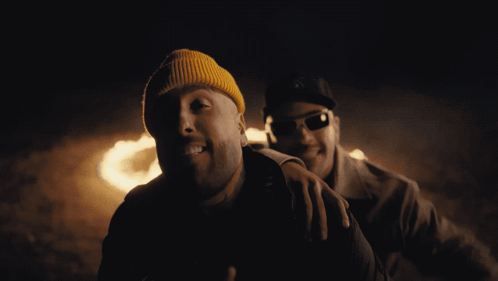 Yellow Beanie and Sunglasses Man Beside Another