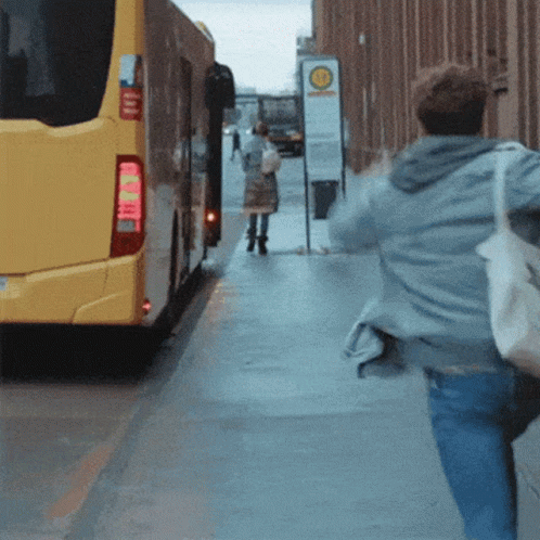 Yellow Bus Driving Past Bahnhof Sign